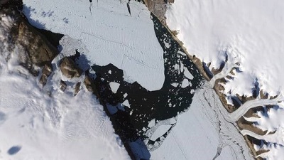 Warming-stoked tides eating huge holes in Greenland glacier